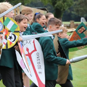 children holding fake swords and shields